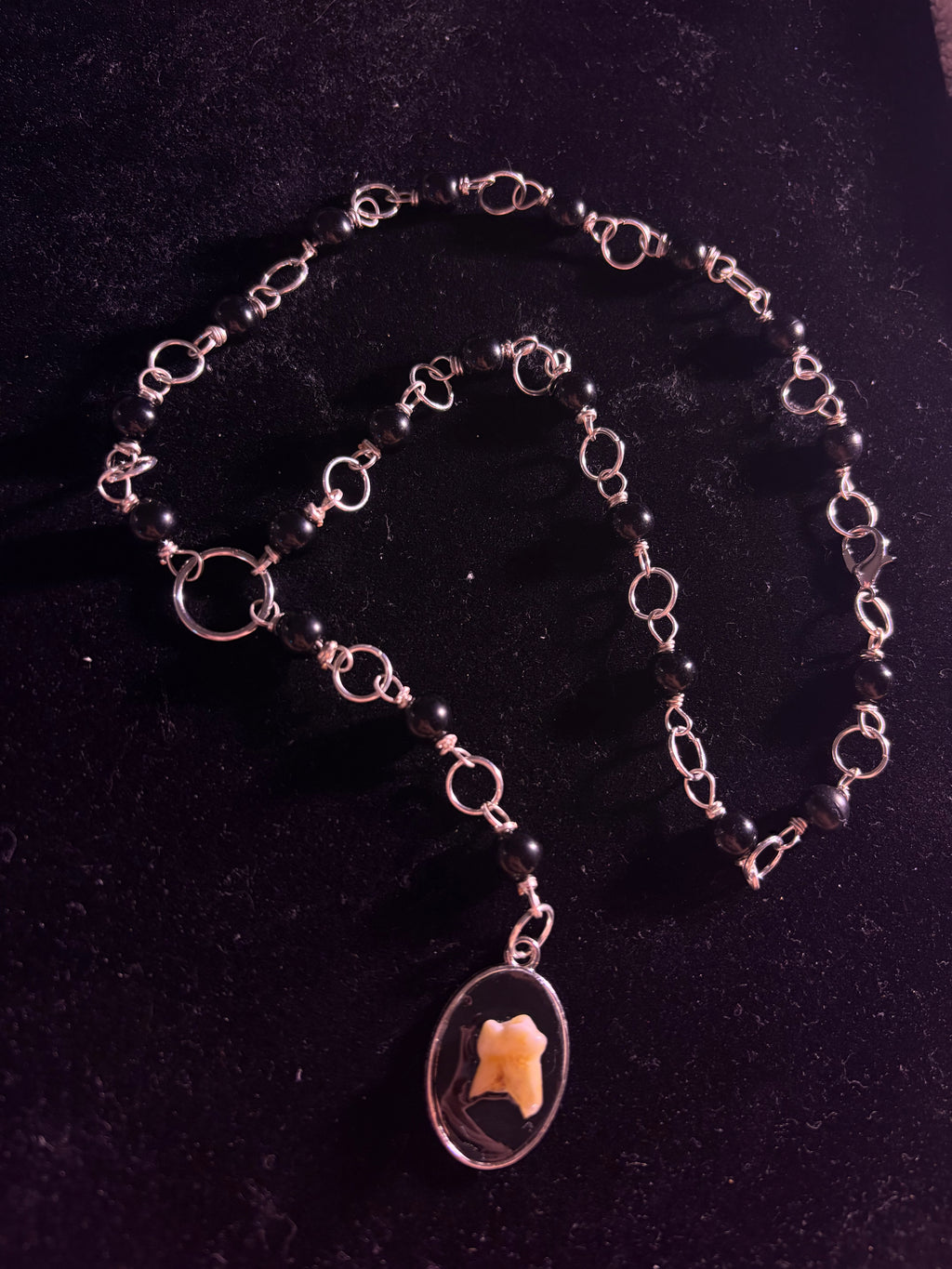 Human tooth rosary
