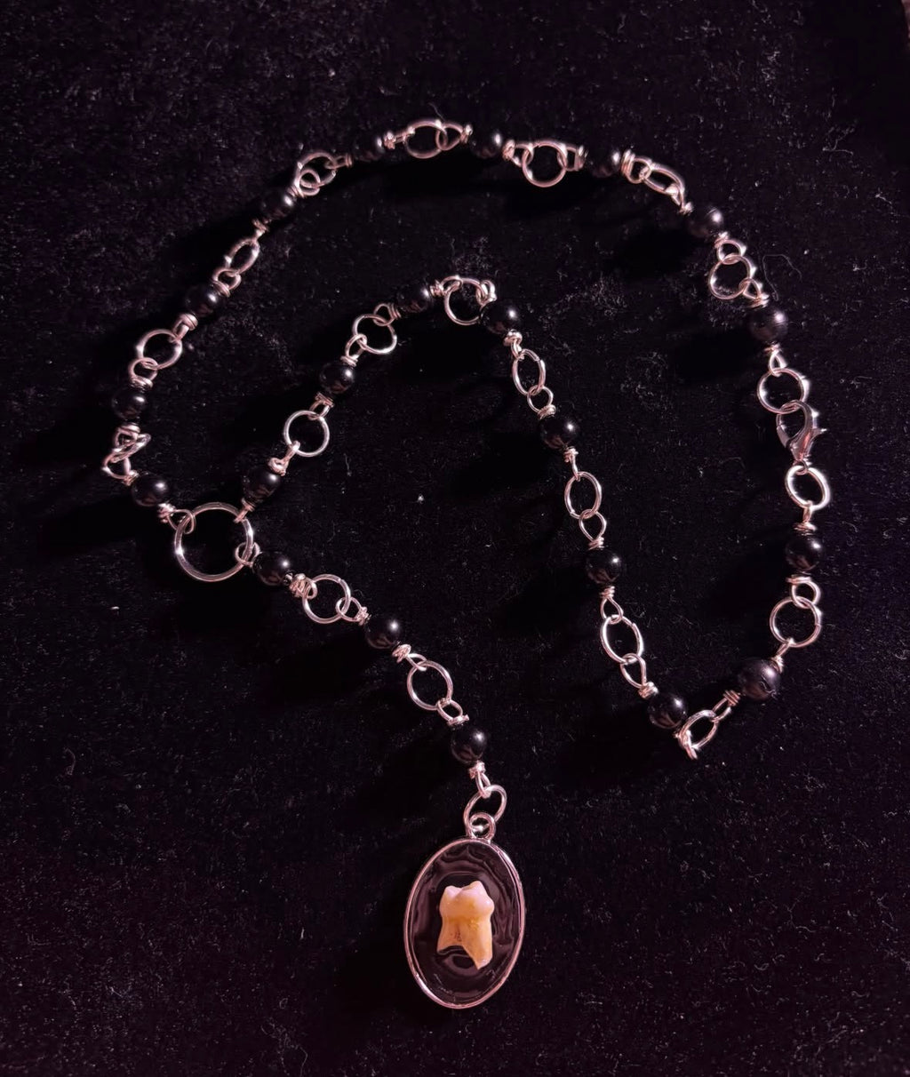 Human tooth rosary