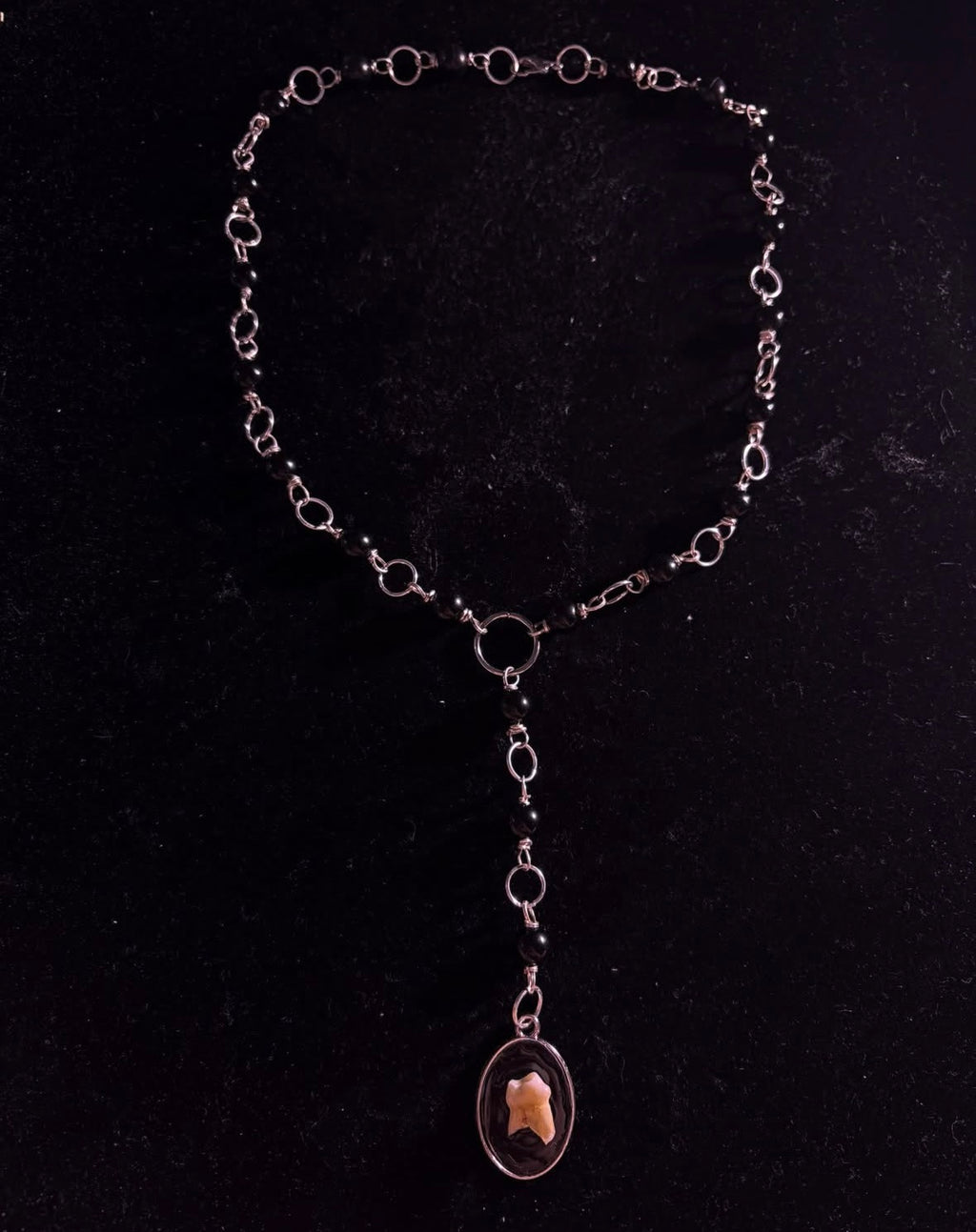 Human tooth rosary